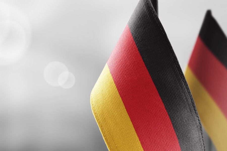 Small national flags of the Germany on a light blurry background. زبان آلمانی (آنلاین) - Image 1